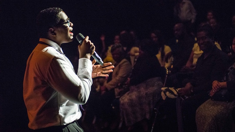 Boy singing on stage