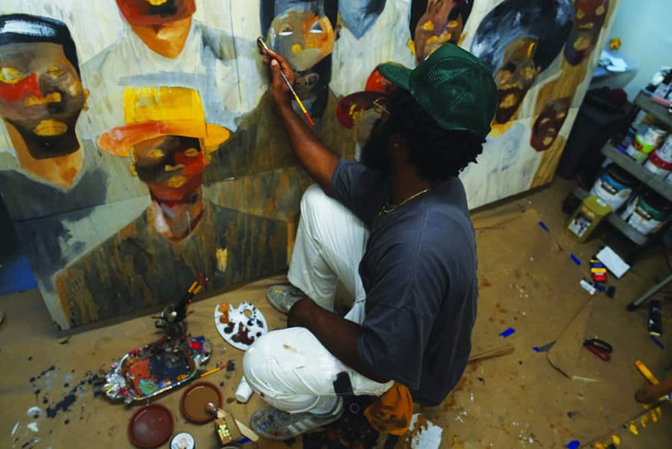 man painting various faces